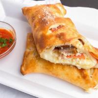Stromboli · Pizza pocket filled with salami, ham and cheese served with a side of tomato sauce.