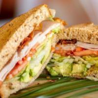 Cali Club Sandwich · Roast turkey breast, applewood smoked bacon, hass avocado, lettuce, tomato, and onion on thi...
