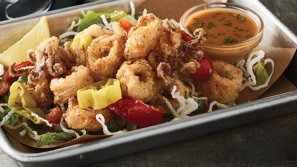 Calamari  · Tender calamari and julienned red peppers lightly breaded and fried. Accompanied with a side of ‘Asian Bang’ sauce.  (1220 cal)