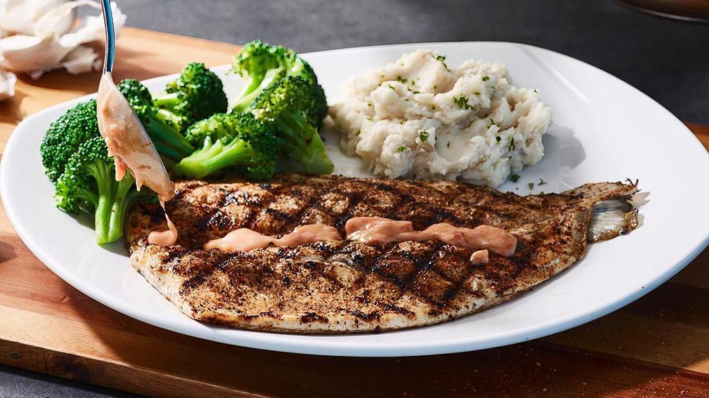 Rainbow Trout · lightly seasoned and wood-grilled (410 cal), served with choice of sauce and two signature sides.