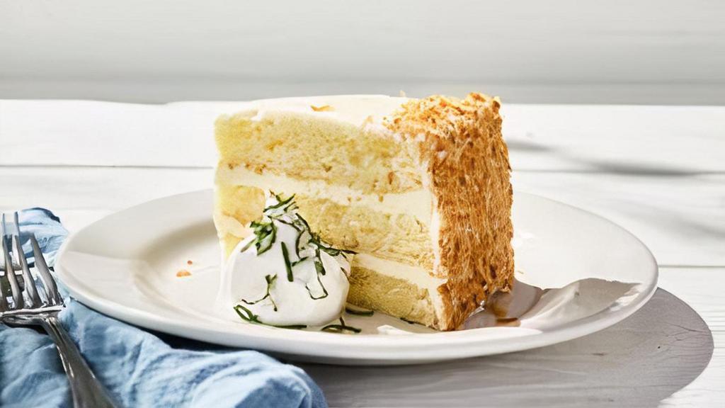 Key Lime Cake · A generous slice of vanilla citrus cake layered with sweet-tart key lime frosting, lightly dusted with coconut. A Bonefish twist on a Florida favorite