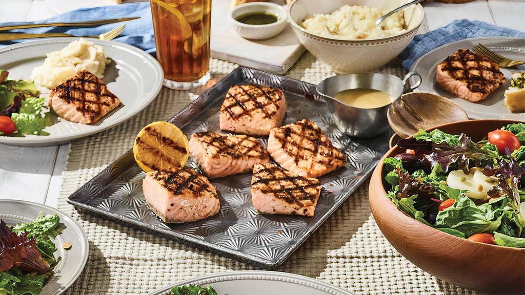 Family Bundle Grilled Salmon · Lightly seasoned wood-grilled salmon with choice of signature sauce. Includes salad, signature side, cookies and fresh bread. Feeds up to 5.