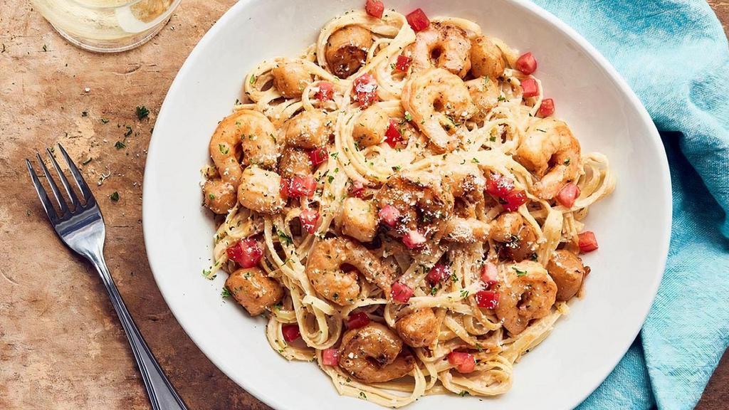 Baja Scallops And Shrimp Scampi  · Tender Bay Scallops, hand-harvested off the Baja coast, tossed with Shrimp in a garlic scampi sauce, topped with fresh tomatoes over linguini