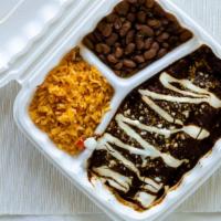 Enchiladas De Mole · Three corn tortillas filled with shredded chicken topped with mole sauce and grated cheese. ...