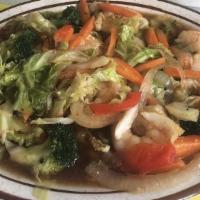 Butter Shrimp · Jumbo Shrimp cooked in a buttery sauce laden with steamed vegetables also accented with herb...