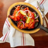 Tandoori Chicken · Half or whole portion of chicken marinated in yogurt, ginger, garlic and spices cooked on a ...