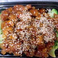 Sesame Chicken · Lightly battered chicken chunks garnish with steamed broccoli and sauteed with tangy sauce t...