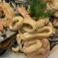 Black Seafood Linguine · Black ink linguine with squid, shrimps, mussels, clams, and creamy lobster sauce.