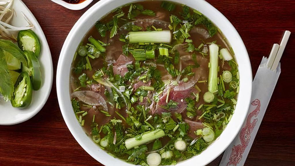 Pho Tai · Vietnamese noodle soup with filet steak. Vietnamese Pho broth takes over 15 hrs of cook time. Served with thin rare eye found steak, cooked brisket, Mank steak, tripe, beef tendon, and Asian beef meatball served with a fresh plate of bean sprouts, Thai basil, jalapeno, and a lime wedge.