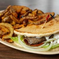 Gyro · Gyro meat with Lettuce, Tomato, Onions, and Tzatziki sauce on a Pita.