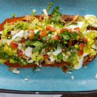 Super Huaraches · Traditional Mexican dish (oblong shape) consisting of corn masa dough little fried with refr...