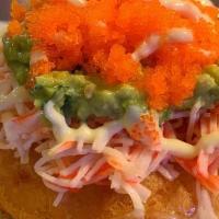 Sushi Donut · Sticky rice filled with cream cheese, and deep fried. Topped with crab mix, guacamole, masag...