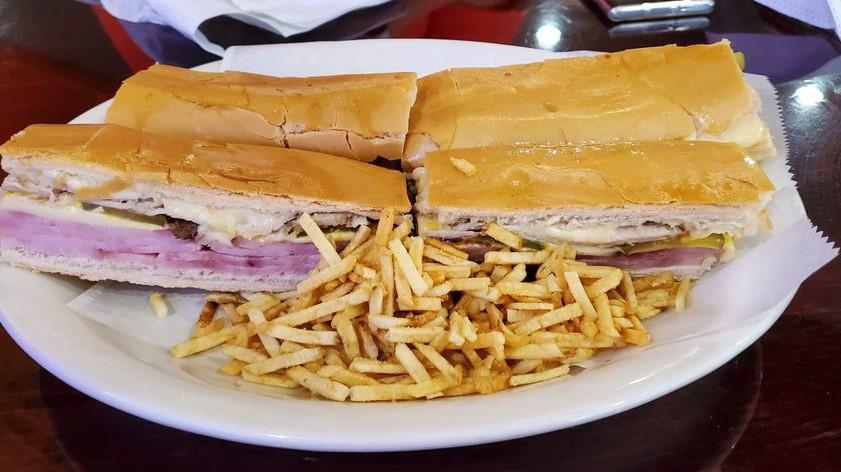 Cuban Sandwich Regular · Ham, pork, swiss cheese, pickles and mustard on a toasted cuban bread with potatoes sticks.
