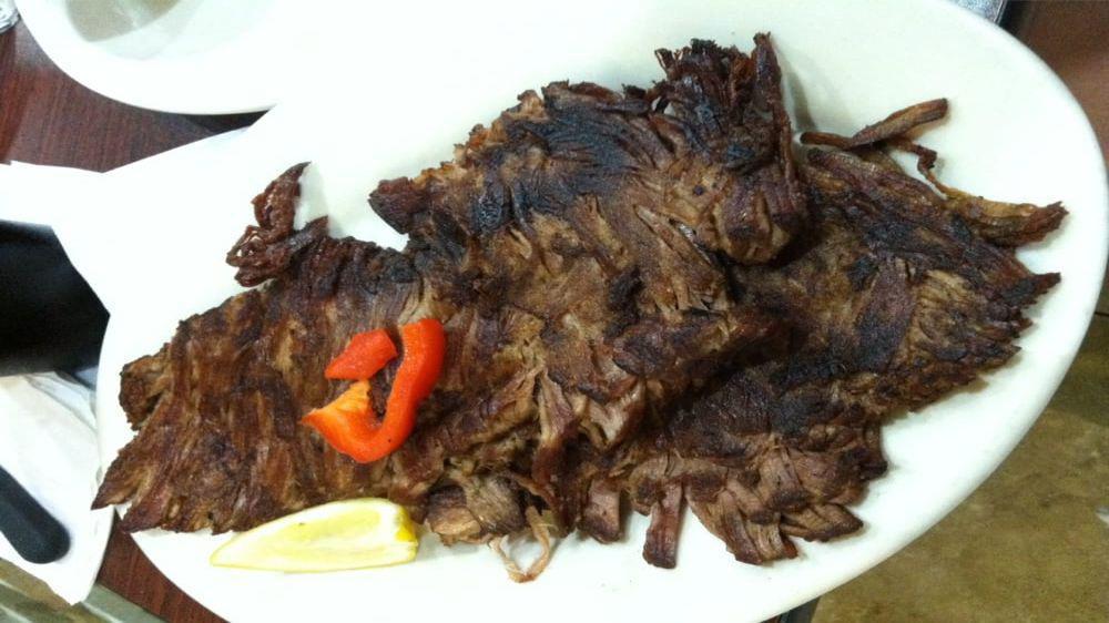 Vaca Frita · A shredded steak grilled topped with sliced onions.