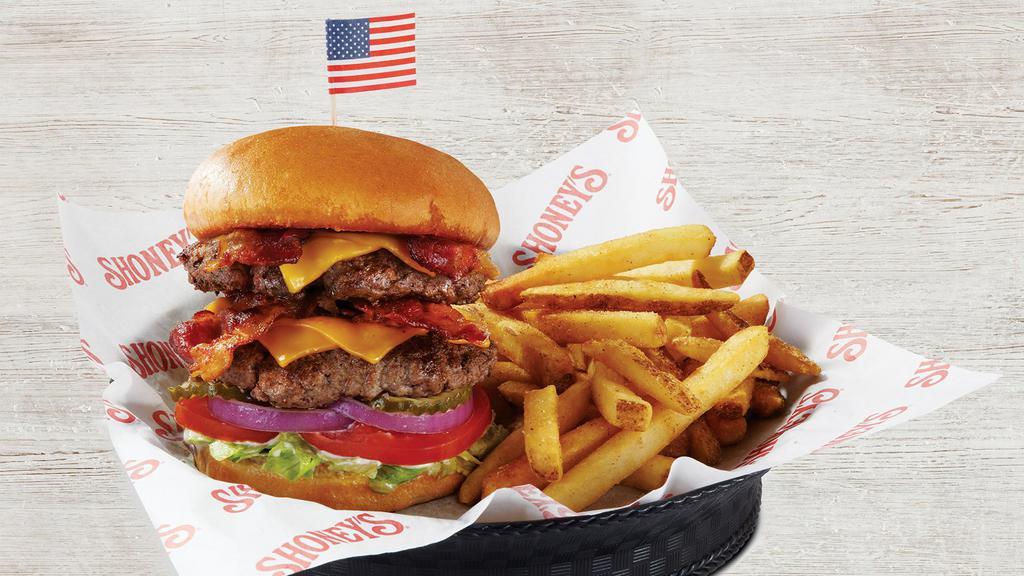 Shoney'S® Double Decker Burger · Topped with four slices of crispy hickory-smoked bacon and four slices of American cheese. Served on a toasted bun with lettuce, tomatoes, red onions, pickles, and mayonnaise. Served with French fries.