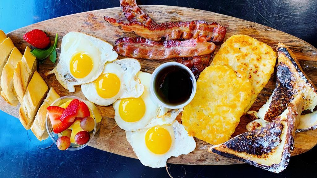 Super Magda'S · 3 slices bacon or sausages, 4 eggs, 1/2 baguette, 2 hash brown, seasonal fruits, 2 pieces french toast with syrup.