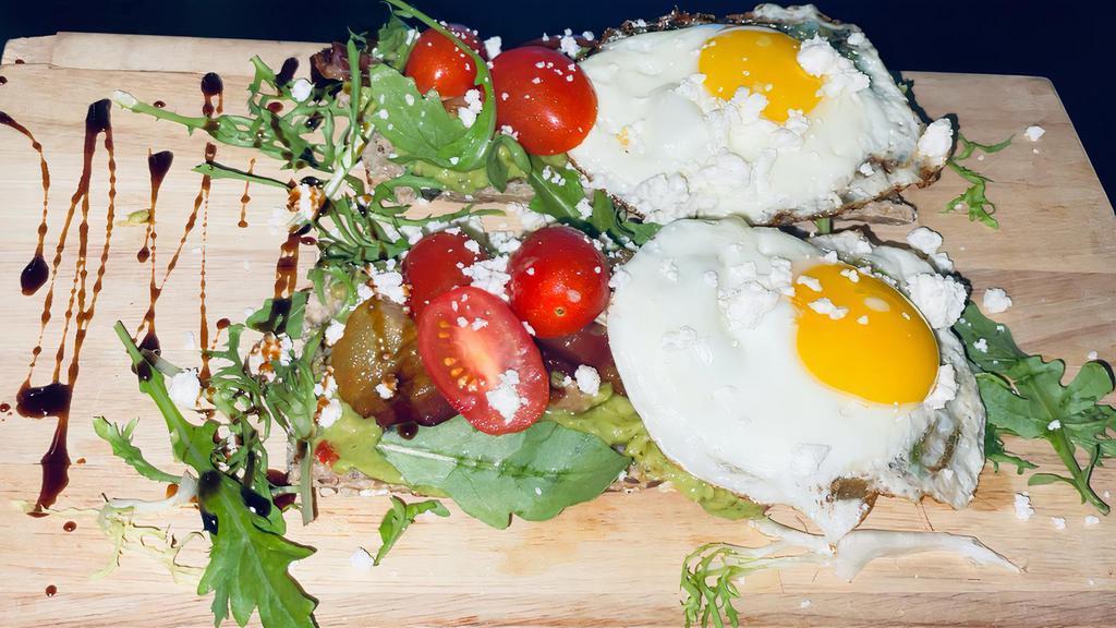 Papillon Avocado Toast · 2 slices of bread topped with, guacamole, arugula, tomatoes cherry, 2 eggs, bacon feta cheese and glace