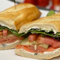 Smoked Salmon Sandwich · Salmon, mixed greens, cream cheese, cucumbers, extra virgin olive oil, and red onions (8 inc...