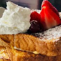 French Toast With Syrup · 3 slices of french toast with syrup and fruits.