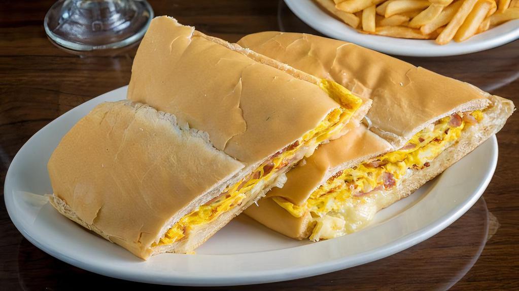 Pan Con Tortilla · Scramble eggs with ham, cheese, and onion on Cuban bread.
