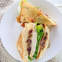 Cranberry Turkey · Thinly sliced turkey, gouda cheese, crispy bacon, and  lettuce on toasted Ciabatta with hous...