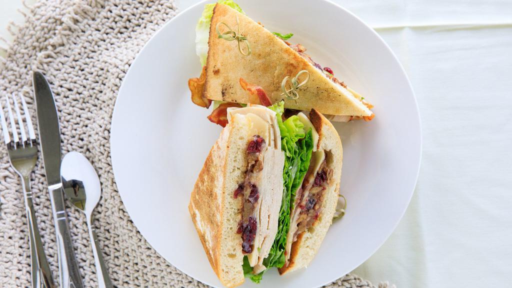 Cranberry Turkey · Thinly sliced turkey, gouda cheese, crispy bacon, and  lettuce on toasted Ciabatta with house-made cranberry-pecan mayonnaise
