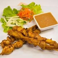 A7 - Satay Chicken · Charbroiled skewers of chicken marinated in a Malaysian peanut-based sauce. Dipped with a sw...