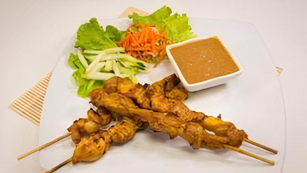 A7 - Satay Chicken · Charbroiled skewers of chicken marinated in a Malaysian peanut-based sauce. Dipped with a sweet and spicy peanut sauce.