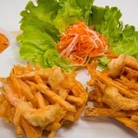 A9 Banh Tom Co Ngu · Strips of sweet potatos and shrimp mixed in a tempura batter, fried until golden. Served wit...