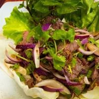 Ss4 Num Tok / Beef Salad · Grilled marinated beef strips, tossed in roasted rice powder, then mixed with chili pepper f...