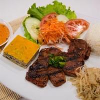 C2 Com Bi Cha Suon Nuong · A juicy pork  chop is browned then lightly seared to a golden hue to trap in the rich marina...