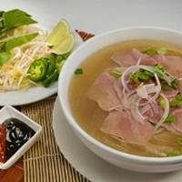 P2  Pho Tai -Rare Steak · A layer of thin, rare eye round steak is cooked by the beef broth right in your bowl, bringi...