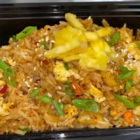 Pineapple Fried Rice · Jasmine Rice, Pineapple, House Made Teriyaki sauce,  Egg, Carrots, Sesame Seeds
