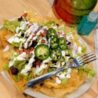Nachos · Chips loaded with beef, with queso & shredded cheese, tomatoes, lettuce, sour cream