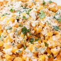 Mexican Street Corn Nachos · Corn, mayo, cotija, cayenne, lime seasoning, nachos and drizzled with a creamy queso
