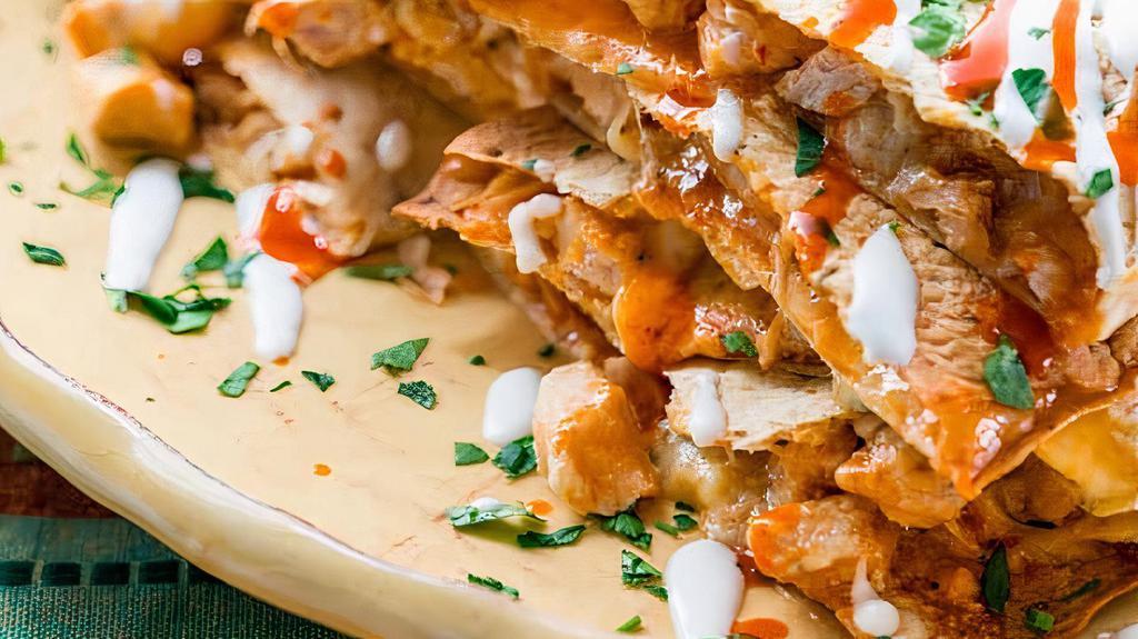 Buffalo Chicken Quesadilla · Seasoned grilled chicken, buffalo wings sauce, ranch dressing and cheese all mixed up together with a hint of bleu cheese stuffed inside of a 14