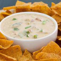 Chips & Queso · Fresh fried tortilla chips and a side of creamy queso