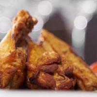 Calypso Chicken Wings · Crispy wings served with choice of sauce: jerk, guava BBQ, orange BBQ or BBQ. Served with fr...
