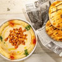 Classic Hummus · Tehina in the middle comes with pita bread.