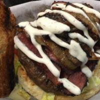 Pastrami Beef Burger · Beef burger topped with grilled pastrami. Served with home cut fries, lettuce, tomatoes and ...