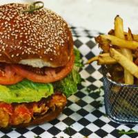 Crispy Cutlet Burger · Corn-flake crusted chicken breast. Served with home cut fries, lettuce, tomatoes and onions.