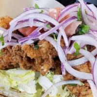 Grouper Po'Boy · Fried chunks of Grouper inside of a hot hoagie on a bed of shredded lettuce topped with our ...
