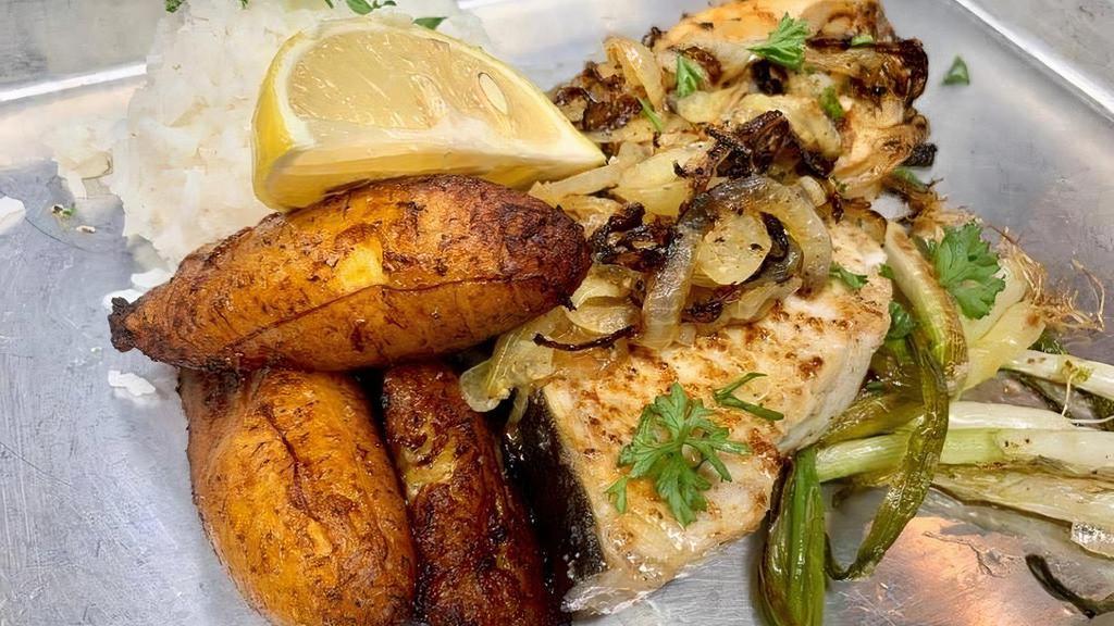 Mojo Grilled Grouper · Thick and juicy grouper fillet marinated in our mojo spices and topped with grilled onions. Served with 2 sides