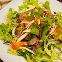 Ss3 - Yum Nuer / Beef Salad · Grilled beef strips mixed with fresh Thai chili, cucumber, tomatoes,  onion,cilantro and dri...