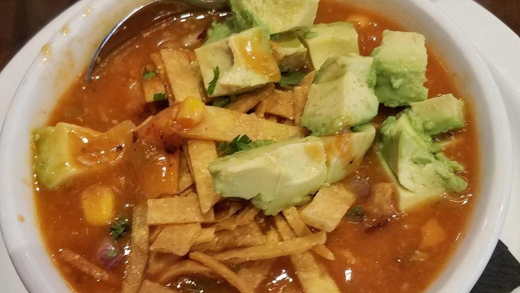 Chicken Tortilla Soup · Grilled chicken, corn, beans, onion, and peppers in a tomato broth and topped with crispy tortilla strips. Add avocado $2.