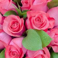 Dozen  Roses · DOZEN OF  ROSES WITH MIXED GREENS WRAPPING IN A BEAUTIFUL PAPER