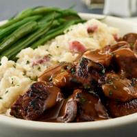 Steak Tips · Seasoned and seared beef tips in our mushroom gravy with creamy mashed
potatoes and steamed ...