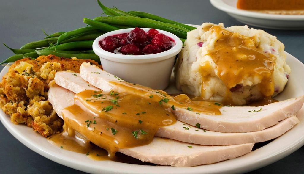 Roasted Turkey Plate · Seasoned turkey breast roasted in-house with rich turkey gravy, cornbread stuffing, creamy mashed potatoes, steamed green beans and cranberry sauce.