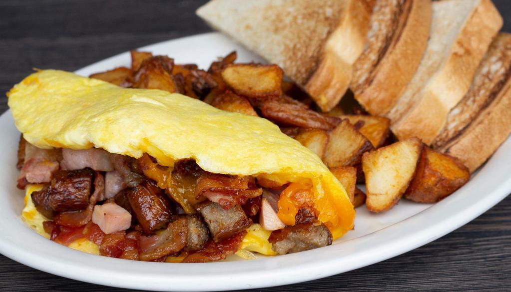 Meat Lovers Omelet · Bacon, sausage, ham and cheddar cheese. Served with toast and your choice of hashbrowns or grits.