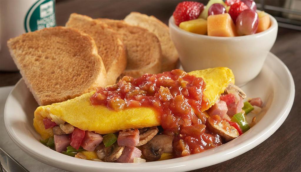Western Omelet · Ham, cheddar cheese, mushrooms, onions, tomatoes and peppers, topped with salsa. Served with toast and your choice of hashbrowns or grits.